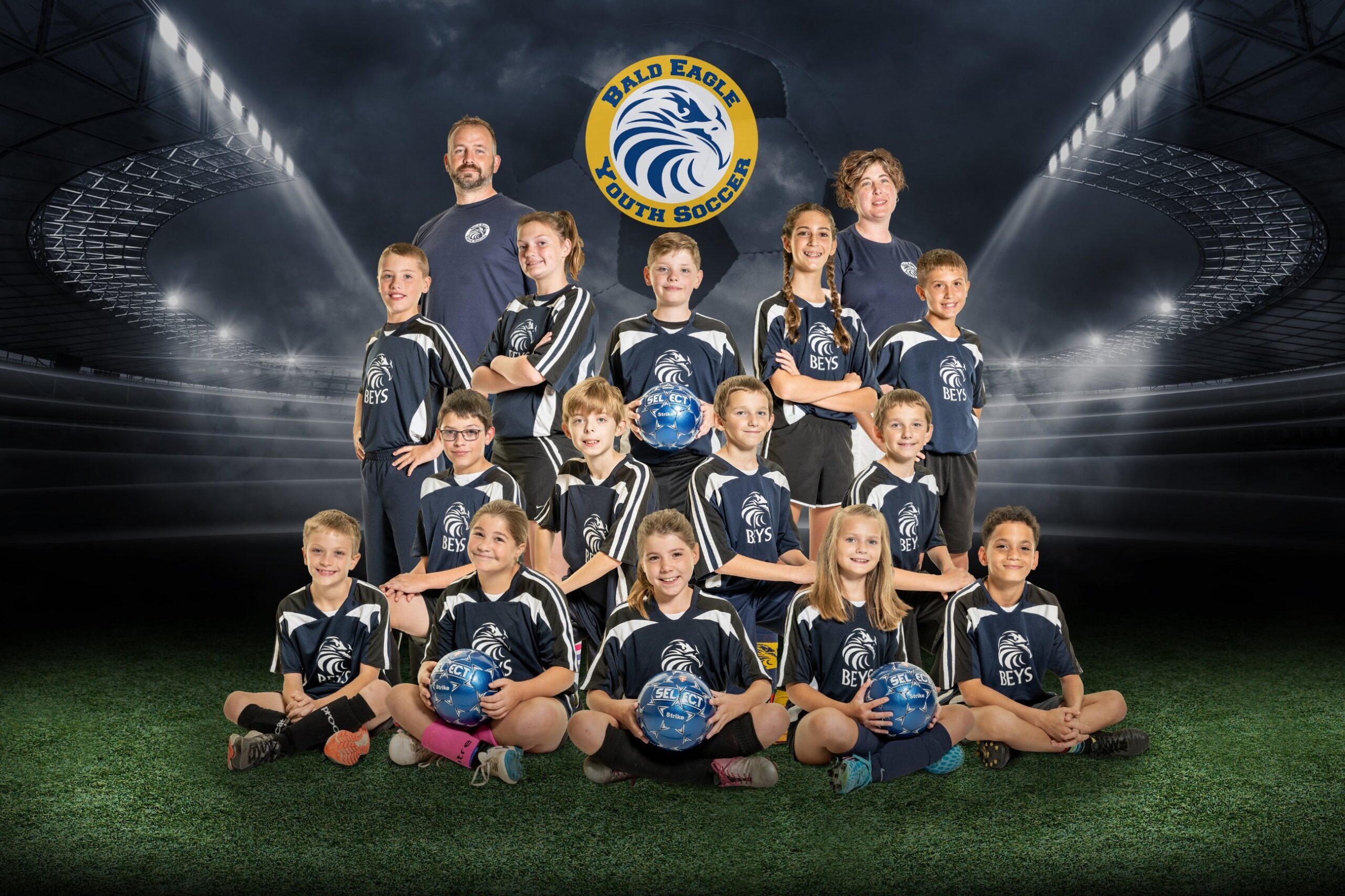Youth soccer team posing on field