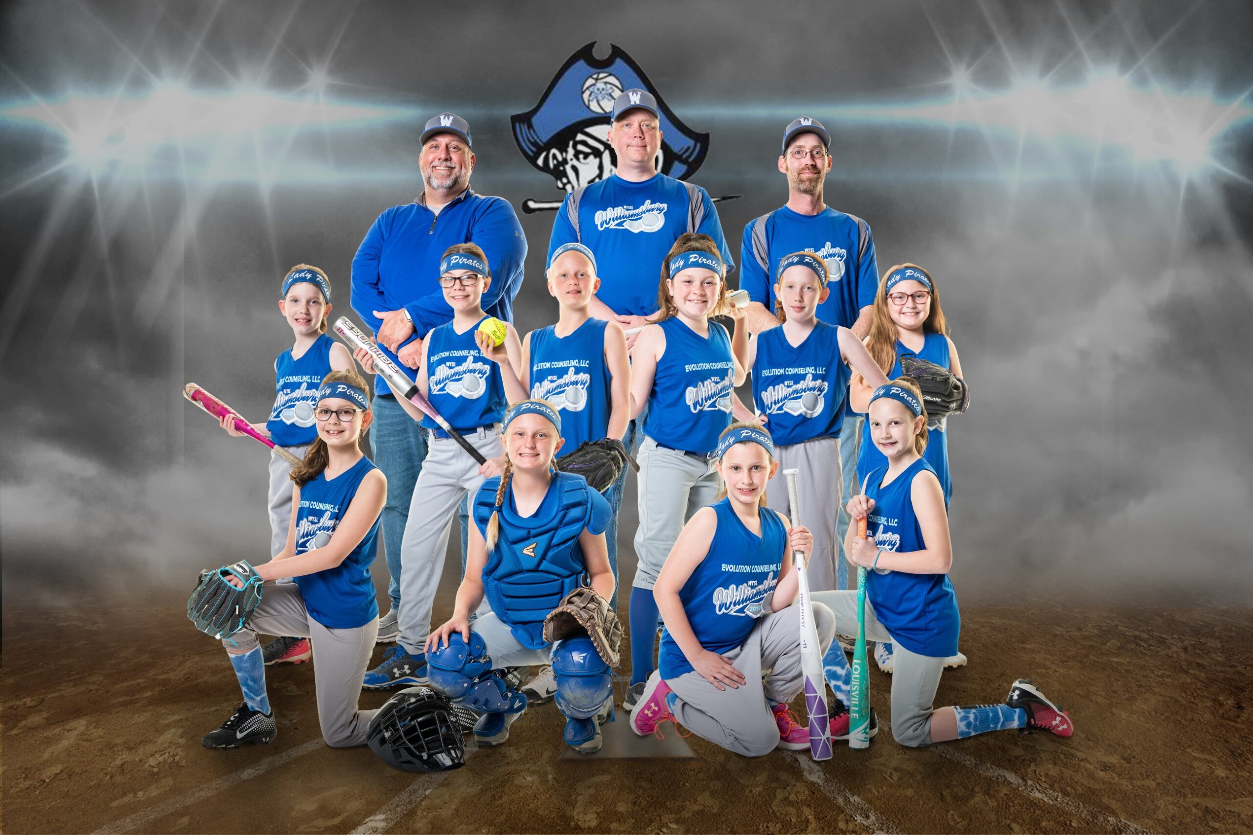 Smiling softball players in blue uniforms