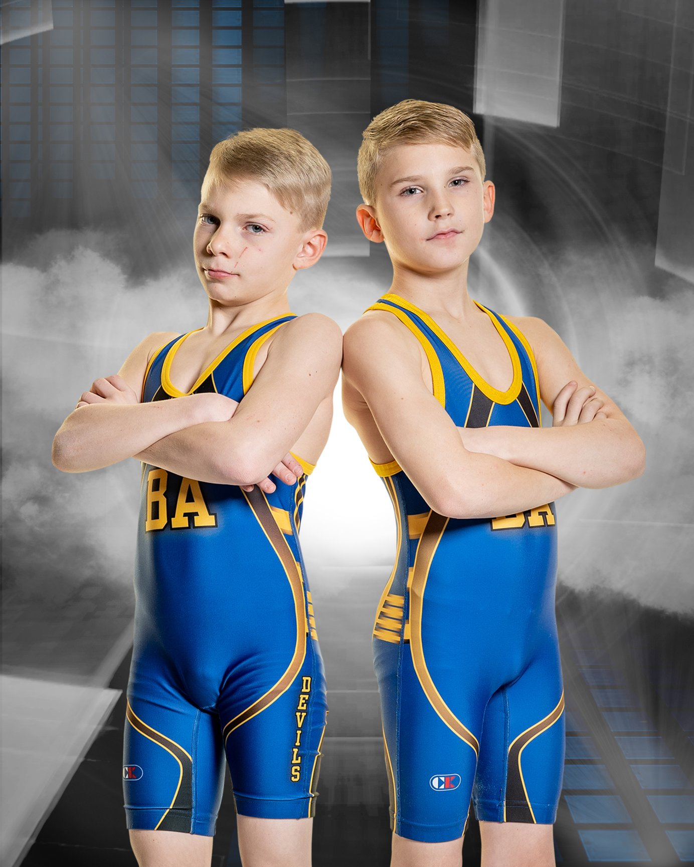 Boys in sports attire with crossed arms.