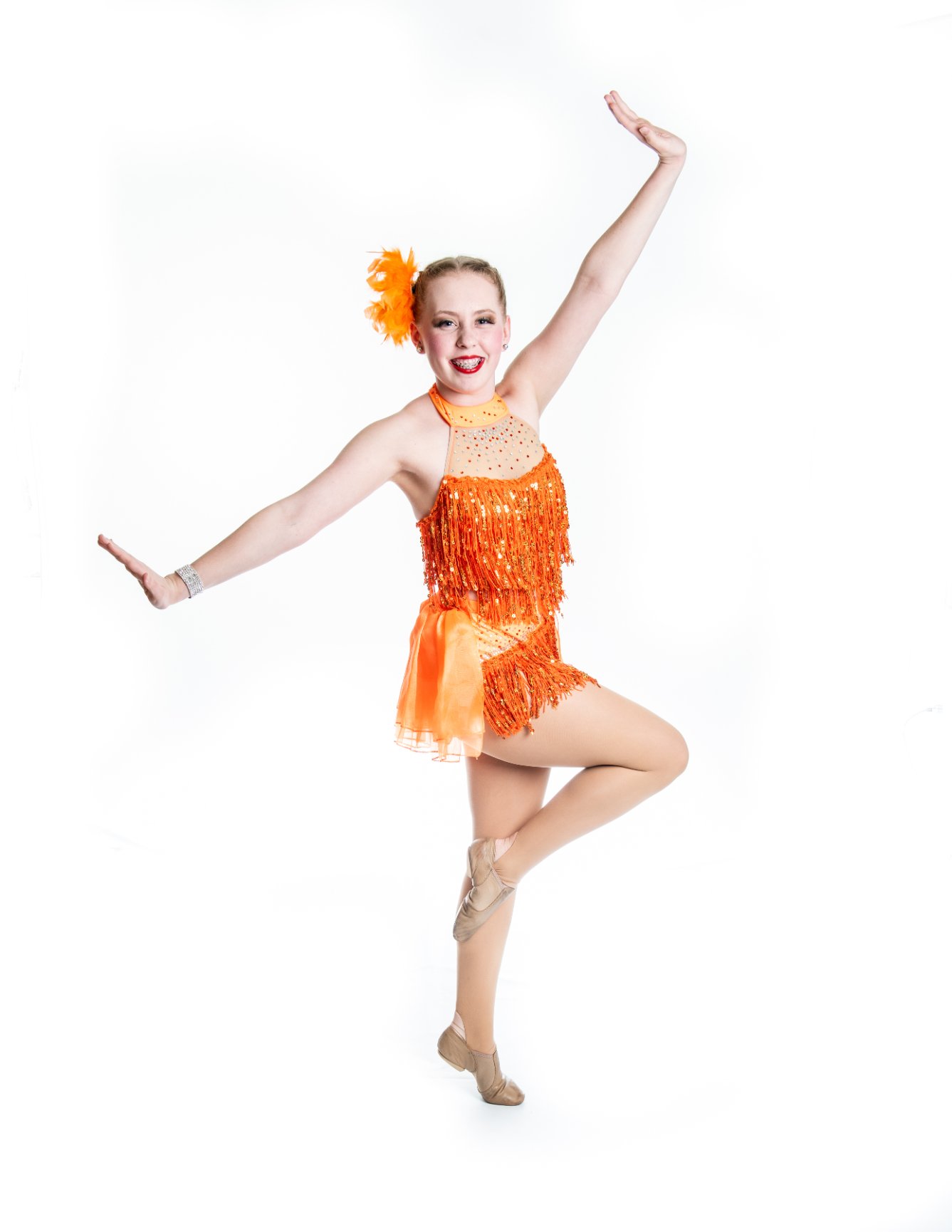 Woman performing dance in orange outfit