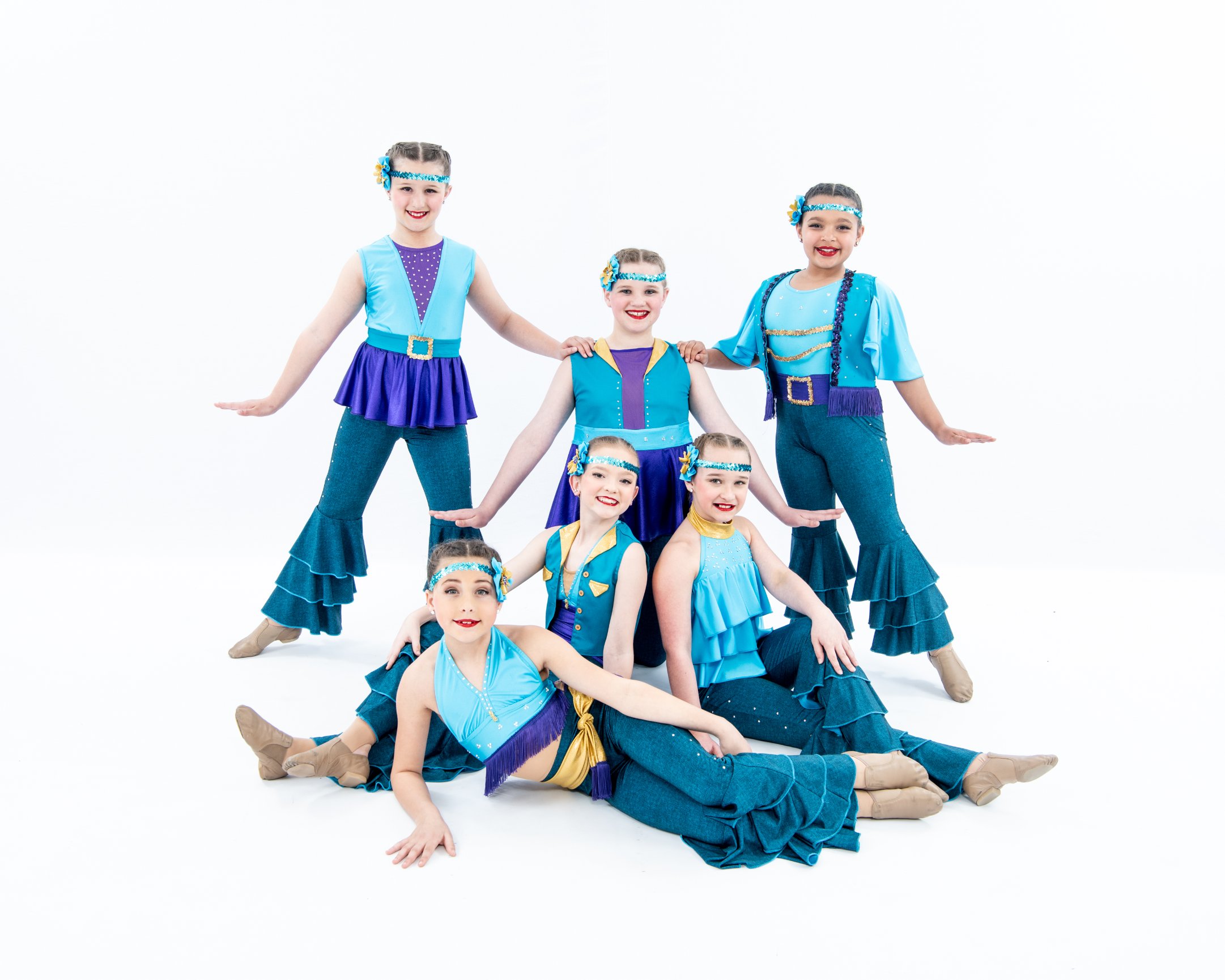 Children in colorful dance costumes posing
