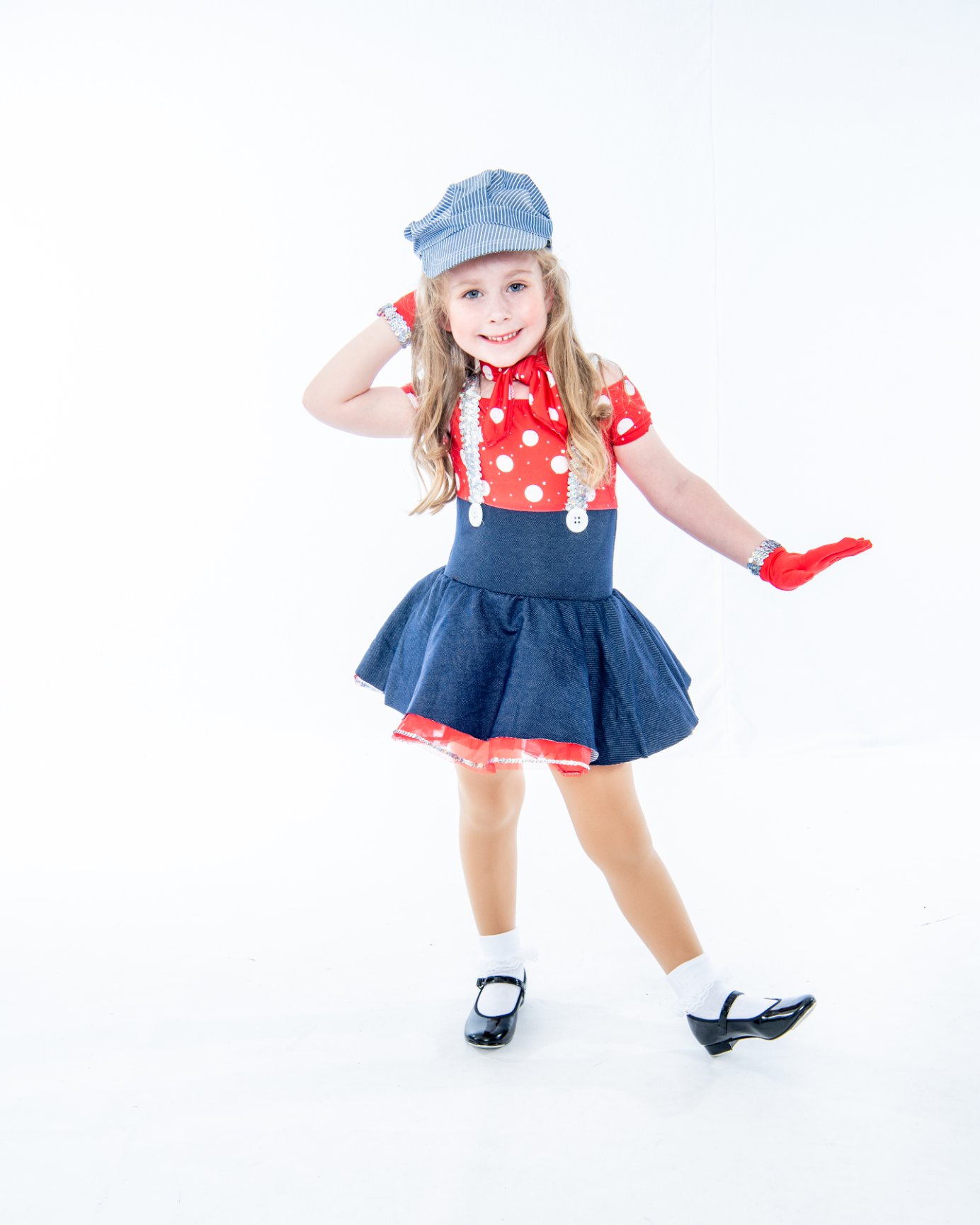 Child in polka dot dress dancing