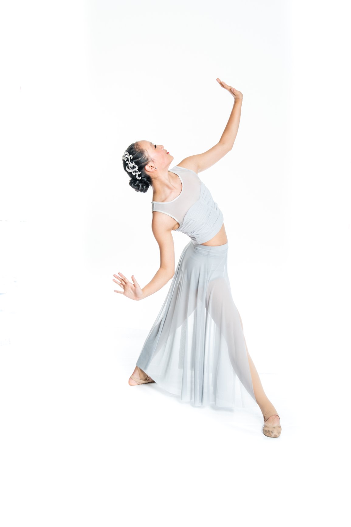 Dancer posing in elegant gray costume