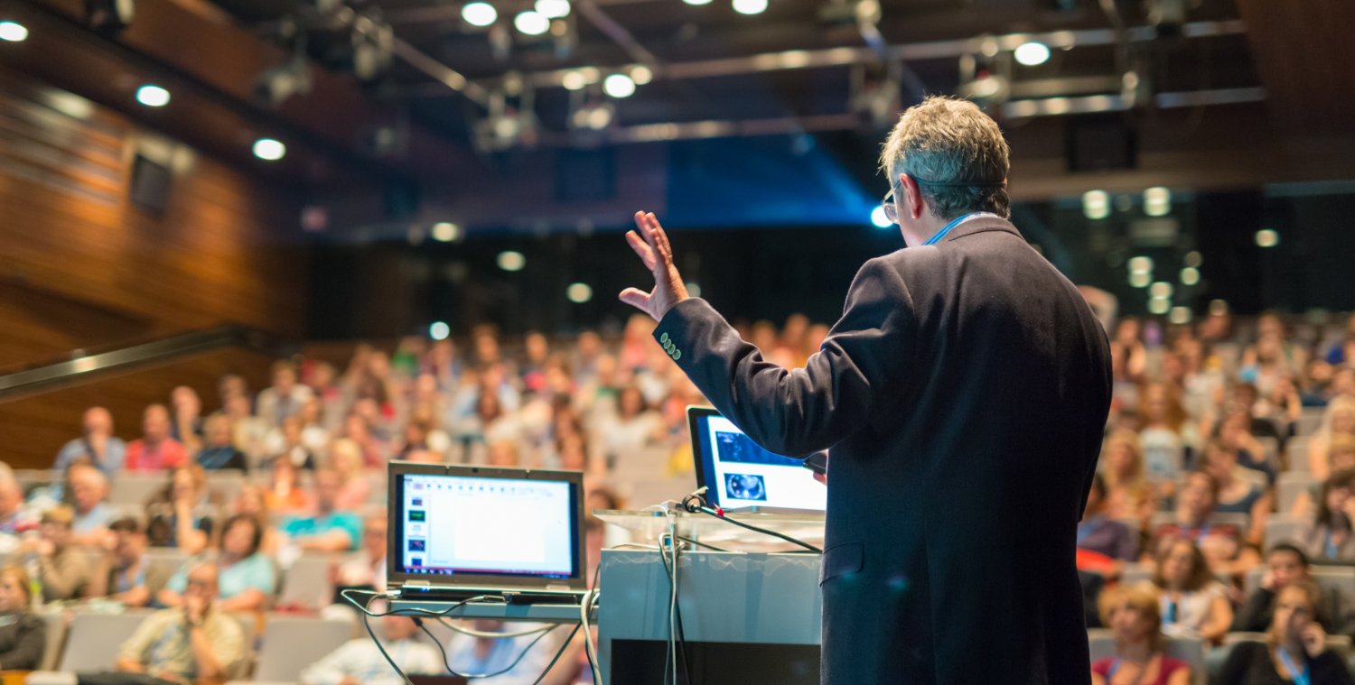 Man delivering lecture at conference