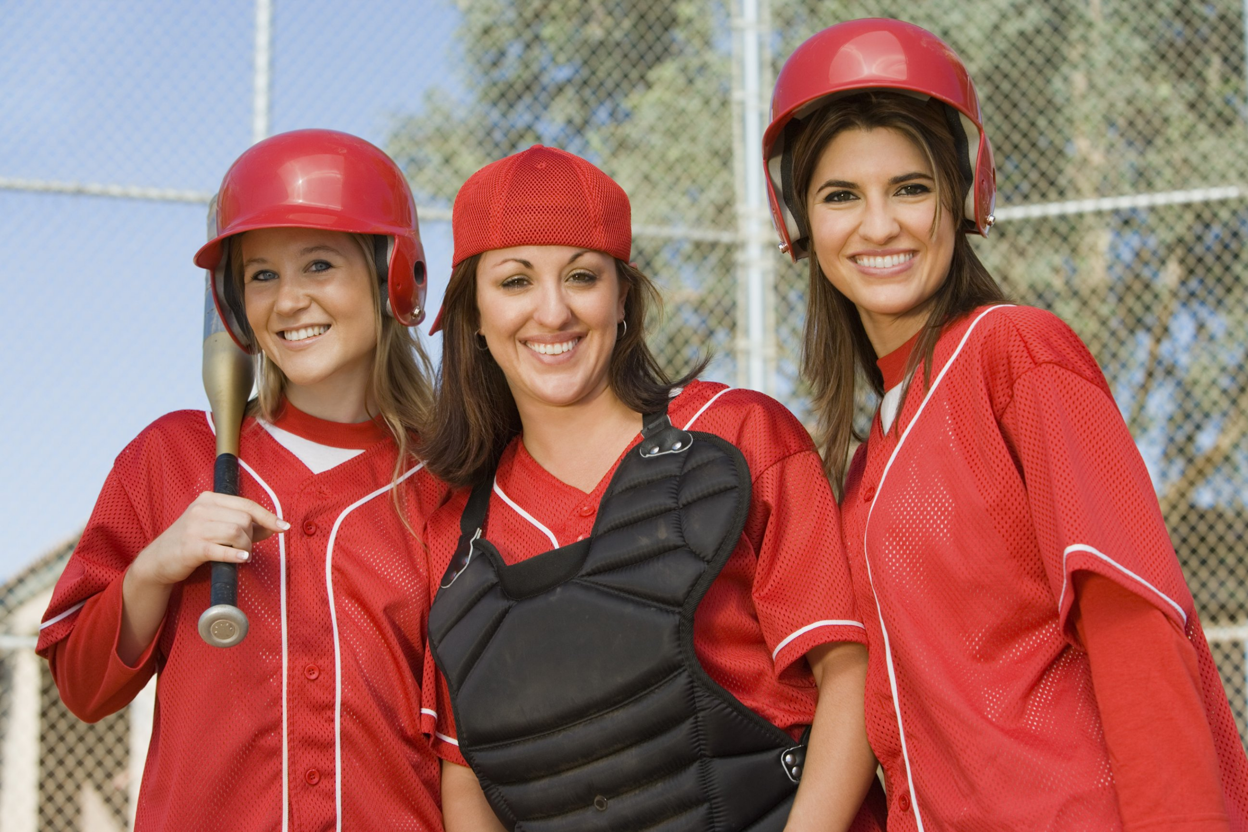 Female softball team members posing together